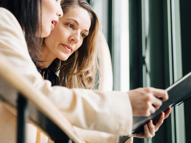 two female executives discussing hsbc cash management two female executives discussing hsbc cash management