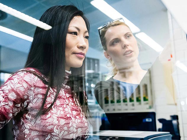 two female executives discussing hsbc liquidity management dashboard two female executives discussing hsbc liquidity management dashboard