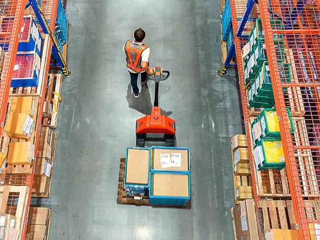 man moving loads inside the warehouse man moving loads inside the warehouse